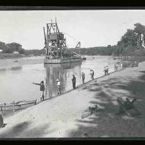 Men fishing from a river bank