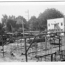 Exterior view of the construction site for the Eagle Theatre. This view shows the progress