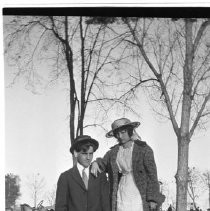 Couple in front of automobile