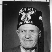 Harry E. Enochs honored by Ben Ali Temple for fifty years of continuous Shrine membership is presented with the coveted 50-year fez