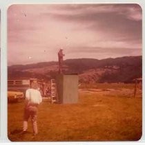 Photographs of Bolinas Bay. Unidentified person standing on small building (outhouse?)