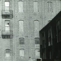 Views of redevelopment sites, renderings, and table models for the proposed Redevelopment District. Includes maps and site plans. This view shows the corner of a typical building slated for redevelopment