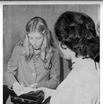 Olympic track star Kathy Hammond (of Carmichael) signs an autograph at a reception held in her honor at the State Department of Education