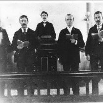 Five men holding books