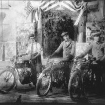 Three men with motorcycles