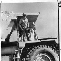 Equipment operator G.L. Burger stands atop a 75-year earth mover