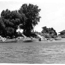 Unidentified Delta beach with swimmers and small boats