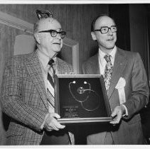 Dr. Carl E. Horn on left, with Dr. Byron Demorest, holding a plaque presented to Dr. Horn from the Sacramento County Medical Society (The Golden Stethoscope Award)