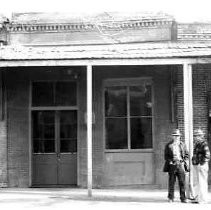 Unidentified building with two unidentified men in front