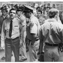 Caption reads: "State correctional officers await report on pay hike bill."