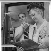 Ella Hertzog, librarian at Sylvan Intermediate School in Citrus Heights, at her surprise retirement party, learns the library will be renamed The Ella Hertzog Media Center. Looking on as she reads her plaque is principal Robert Fries