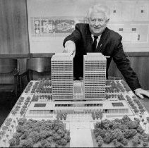 Senator Randolph Collier examines model of Twin Towers office building