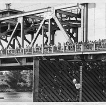 Crowds pose for a picture along the walkway on Tower Bridge