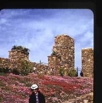 Woman sitting on a rock wall