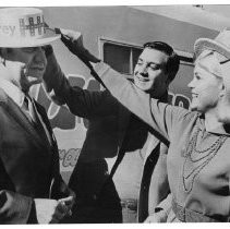 Robert A. Humphrey, son of V.P. Hubert Humphrey, places a Humphrey hat on the head of Assembly Speaker Jesse M. Unruh. Helping Humphrey is his wife, Donna. They were in Sacramento campaigning for Humphrey for President