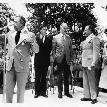 Bob Hope, the legendary comedian and movie and TV star, with public officials as crowd sings Happy Birthday to him