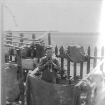 Boy holding a cat standing in a garden area
