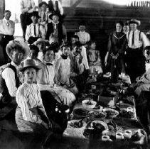 Large gathering of people haivng a meal