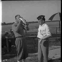 Two unidentified men with trophies