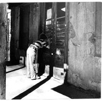 Boy looking through window