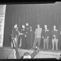 Group of unidentified men on a stage