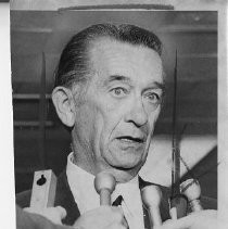 Thomas C. Lynch, California Attorney General, surrounded by news microphones