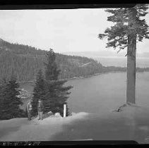 A man and a woman standing next to a lake