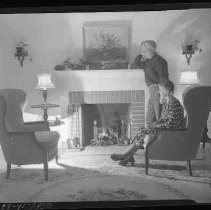 A couple sitting in front of a fireplace