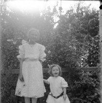Two young girls posing outdoors