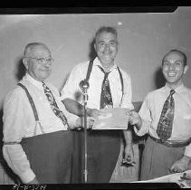 Three men holding a document