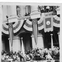 Exterior view of Lt. Governor Frank Merriam at the podium introducing Governor "Sunny" Jim Rolph, with former Governor Clement Young, at the left during the inauguration January 6, 1931 outside the California State Capitol