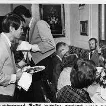 Robert T. (Bob) Matsui helps serve dinner to the winners of a fundraiser to raise money to support Democratic candidates