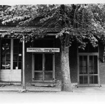 Store front of T.R. Barnes, seller of Singer Sewing Machines and Johnson Washers