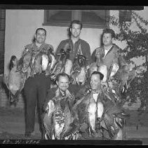 Hunters with dead ducks