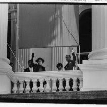 Queen Elizabeth II and Prince Phillip (husband of Queen) wave from the balcony of the State Capitol in Sacramento