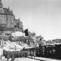 A troop of soldiers disembarking from a train