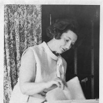 Mrs. Frank M. (Alberta) Jordan, looking through some papers