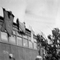 Young girl standing in front of old street car