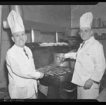 Two chefs grilling