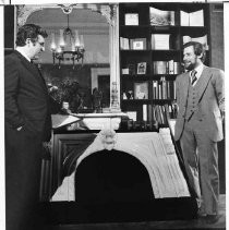 Caption reads: Mansion Fireplace to Warm Capitol: Assemblyman Louis J. Papan, left, inspects an 1880 African white marble, coal-burning fireplace