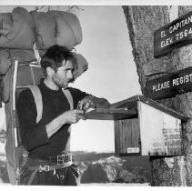 Warren Harding, 34, of West Sacramento, the leader of the first team to climb El Capitan, signing the park service register at the summit