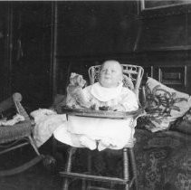 Unknown child in high chair indoors