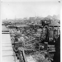 Exterior view of General Stores in Southern Pacific Company's railyards. This view is just after a fire in the yard. Note the Consurmer's Ice House in the background