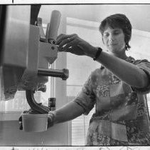 Bonnie Harned filling a cup with soft ice cream, in her shop selling diet ice cream, drinks, candy, etc, in Live Oak, Sutter County