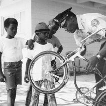 Policeman Repairs Bicycle