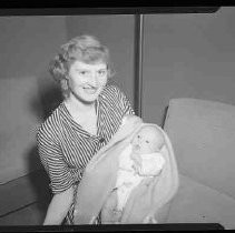 A young woman holding a baby