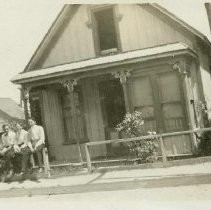 Five guys on a fence rail