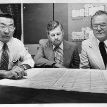 Ed Kado (Architect), William J. Robbins, Sr., and H.I. Nielsen at a press conference to discussing razing of Senator Theater