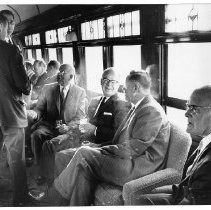 Rex T. Kearney, seated facing the camera, President of the Sacramento Northern Railway Company and others of the Western Pacific Railroad Company are aboard the last train over the Tower Bridge in 1962