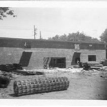 Exterior view of the construction site for the Eagle Theatre. This view shows the progress